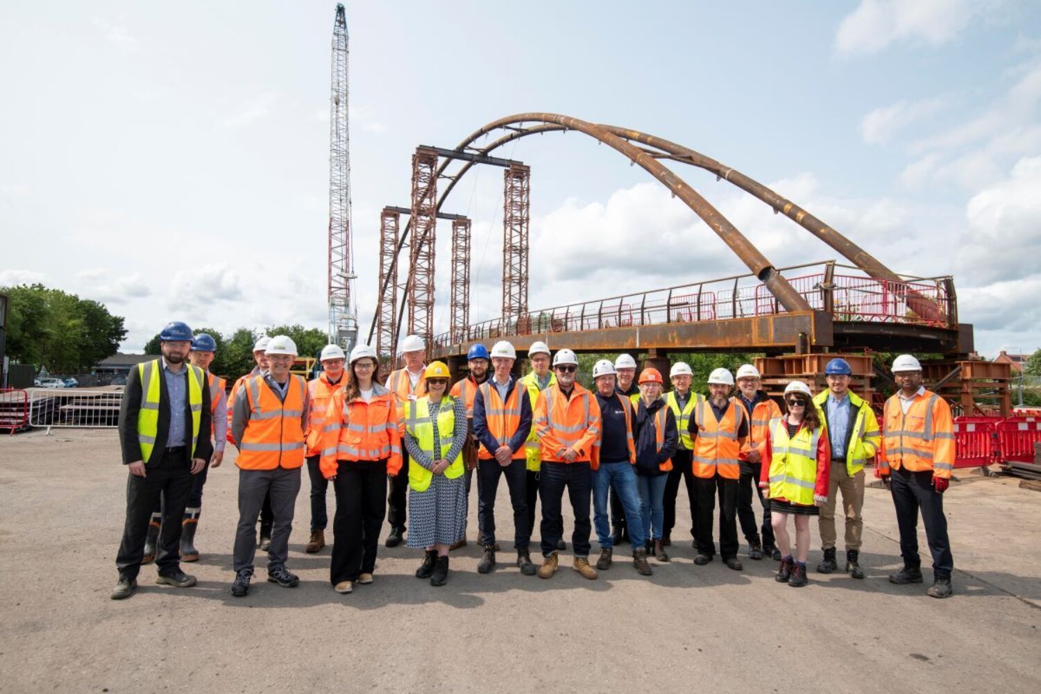 A group of people stood in front of a bridge