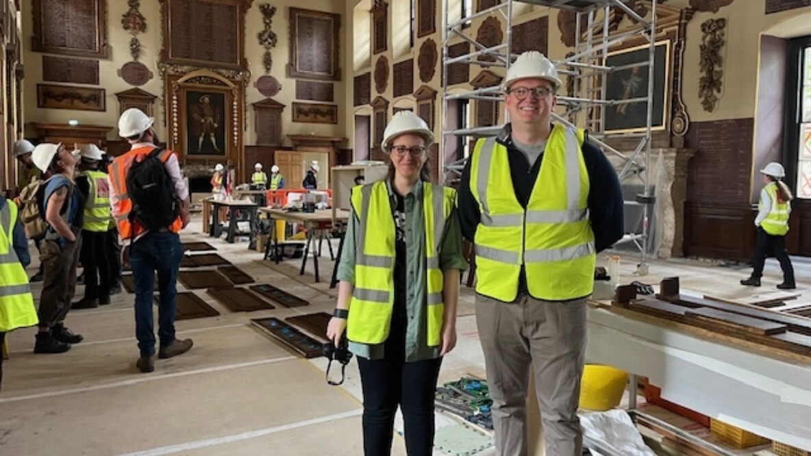 Neli and Ed standing side by side wearing hard hats and high vis vests